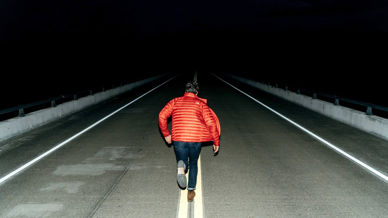 Man-Running-on-Road-at-Night-Time_OZcDVbz1u8fX